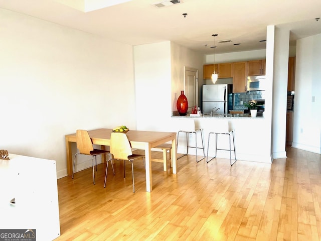 325 E Paces Ferry Rd NE Unit 1606, Atlanta, GA 30305 - dining space with light wood finished floors and baseboards