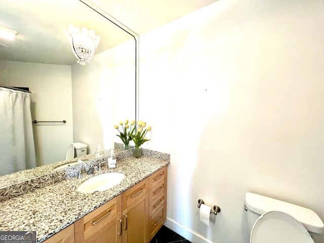 325 E Paces Ferry Rd NE Unit 1606, Atlanta, GA 30305 - full bath with toilet, vanity, baseboards, and tile patterned flooring