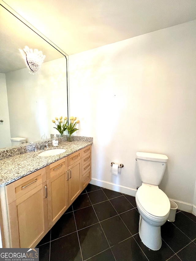 325 E Paces Ferry Rd NE Unit 1606, Atlanta, GA 30305 - bathroom with toilet, tile patterned floors, baseboards, and vanity