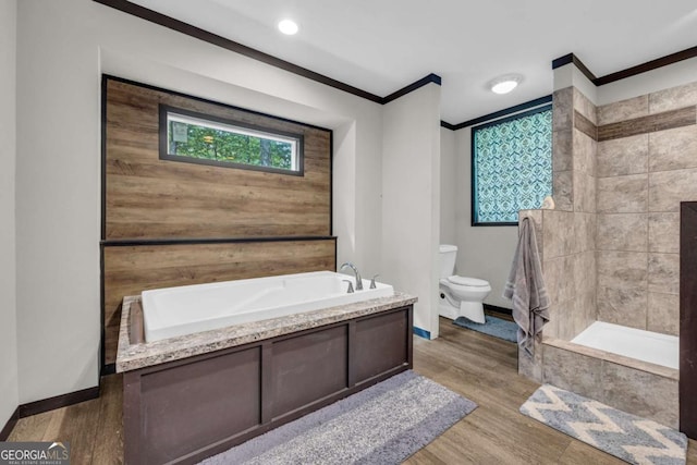 315 April Trce, Dawsonville, GA 30534 - full bathroom featuring ornamental molding, toilet, a bath, baseboards, and wood finished floors