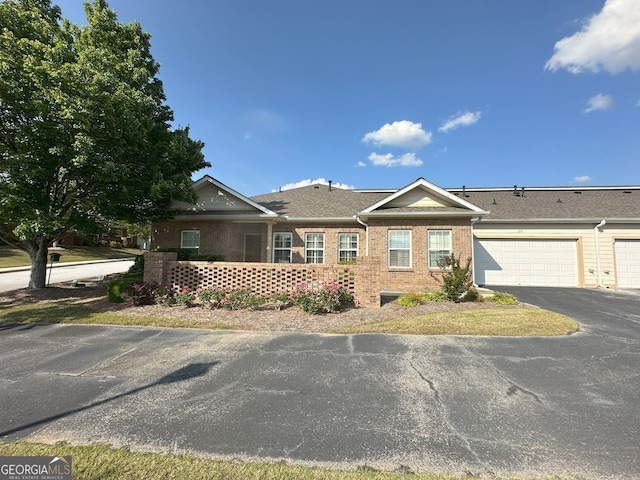 125 Villa Park Cir, Stone Mountain, GA 30087 - view of front of home with brick siding, driveway, an attached garage, and a shingled roof