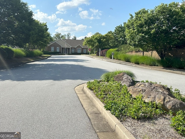125 Villa Park Cir, Stone Mountain, GA 30087 - view of asphalt road featuring curbs and traffic signs