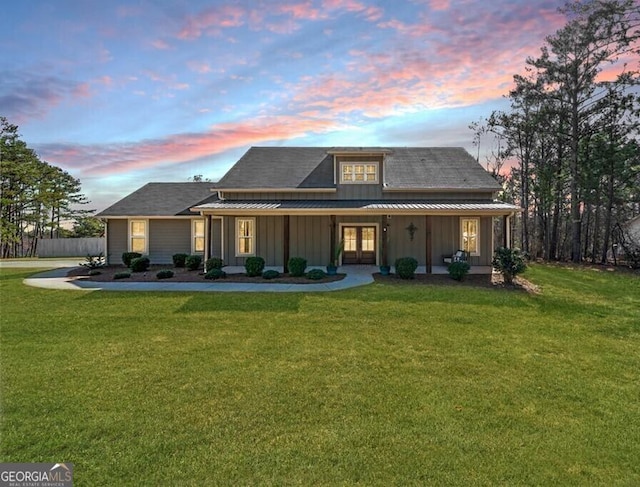 8007 Wishaw Ct, Douglasville, GA 30187 - farmhouse with board and batten siding, a front yard, french doors, and a porch