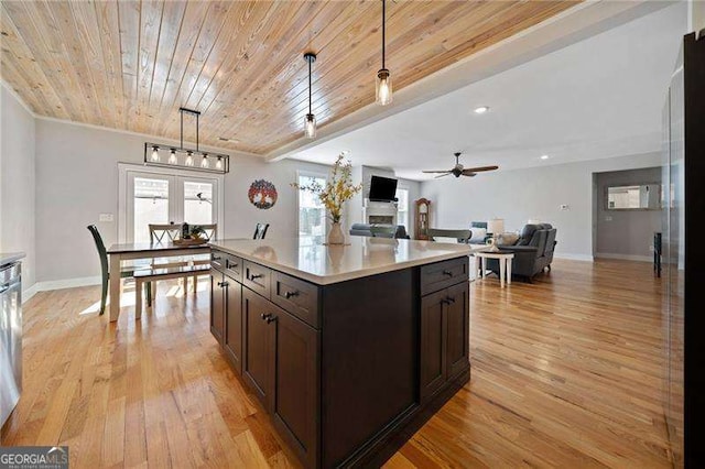 8007 Wishaw Ct, Douglasville, GA 30187 - kitchen with a ceiling fan, dark brown cabinets, light countertops, light wood-style floors, and wooden ceiling