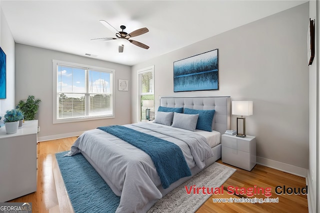 8007 Wishaw Ct, Douglasville, GA 30187 - bedroom featuring baseboards, light wood finished floors, and ceiling fan