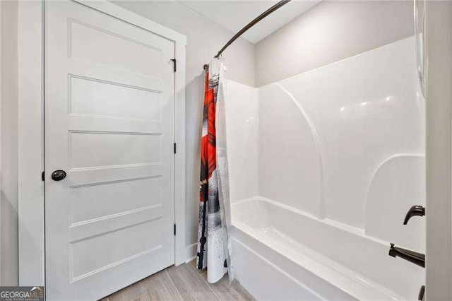8007 Wishaw Ct, Douglasville, GA 30187 - full bath featuring shower / bath combination with curtain and wood finished floors