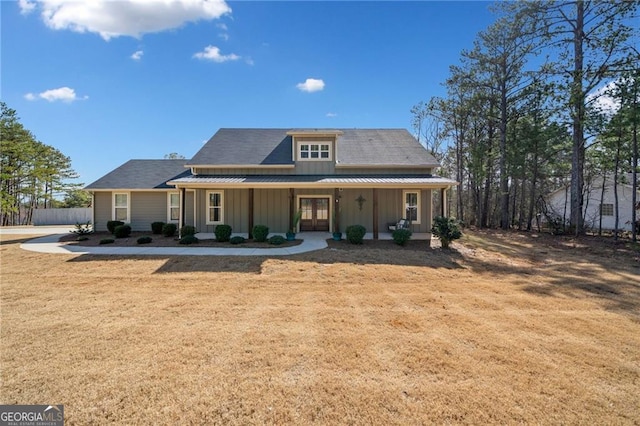 8007 Wishaw Ct, Douglasville, GA 30187 - farmhouse inspired home featuring board and batten siding, french doors, a front yard, and covered porch
