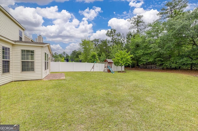 view of yard with a playground and view of scattered trees