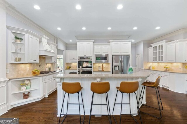 3302 Anna Ruby Ln, Buford, GA 30519 - kitchen featuring appliances with stainless steel finishes, open shelves, premium range hood, crown molding, and white cabinets