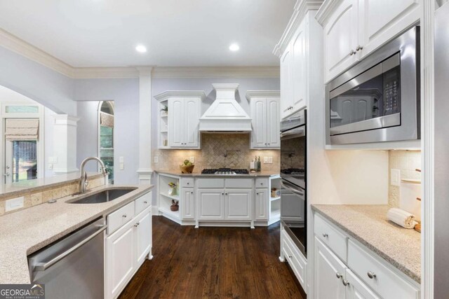 3302 Anna Ruby Ln, Buford, GA 30519 - kitchen with a sink, appliances with stainless steel finishes, open shelves, custom exhaust hood, and ornamental molding