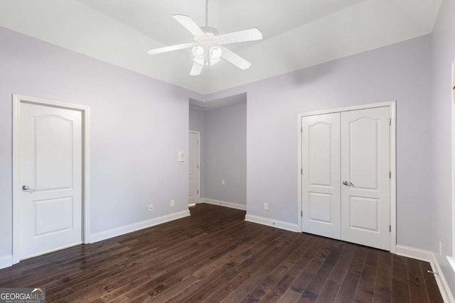 3302 Anna Ruby Ln, Buford, GA 30519 - unfurnished bedroom featuring dark wood-type flooring, baseboards, and a ceiling fan