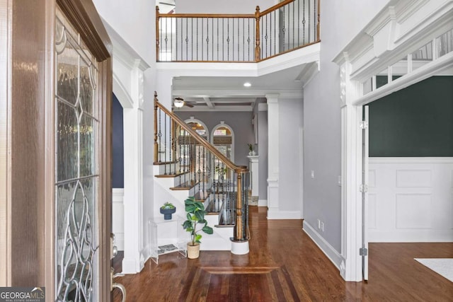 3302 Anna Ruby Ln, Buford, GA 30519 - entrance foyer with wood finished floors, a high ceiling, stairs, ornate columns, and a ceiling fan