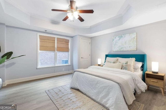 3302 Anna Ruby Ln, Buford, GA 30519 - bedroom featuring a raised ceiling, ornamental molding, wood finished floors, baseboards, and a ceiling fan