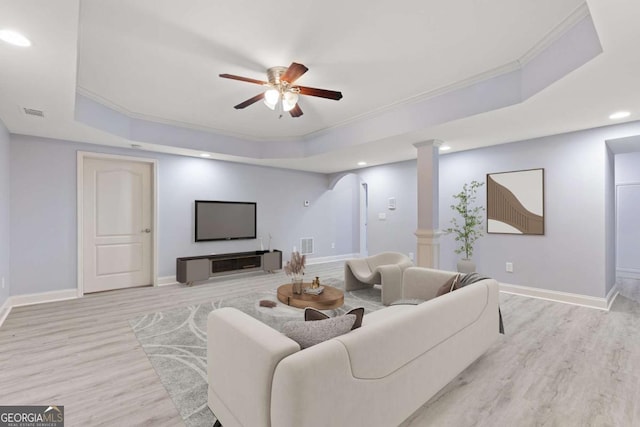3302 Anna Ruby Ln, Buford, GA 30519 - living area featuring a tray ceiling, ornate columns, ceiling fan, light wood-style flooring, and crown molding