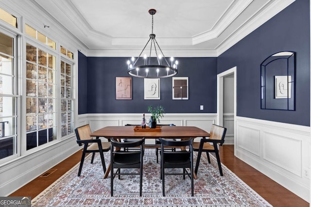 3302 Anna Ruby Ln, Buford, GA 30519 - dining room with a chandelier, a raised ceiling, wainscoting, dark wood-style floors, and crown molding