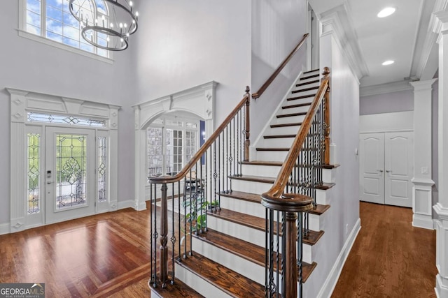 3302 Anna Ruby Ln, Buford, GA 30519 - foyer entrance featuring a high ceiling, healthy amount of natural light, stairway, wood finished floors, and crown molding