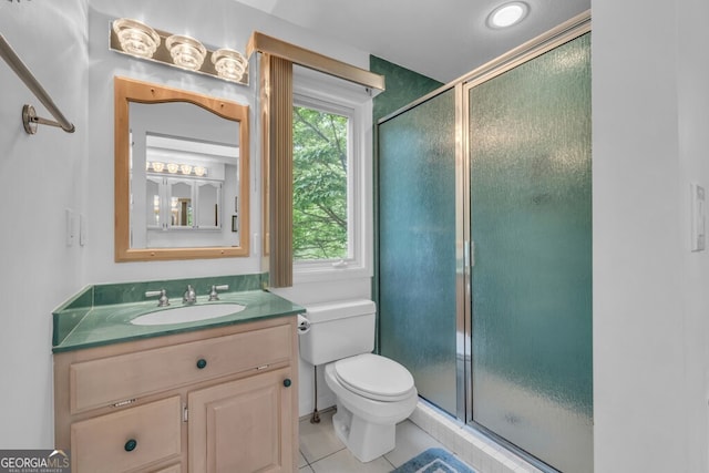full bath with a stall shower, tile patterned floors, toilet, and vanity