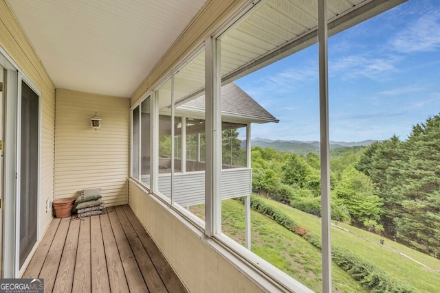 unfurnished sunroom featuring a mountain view