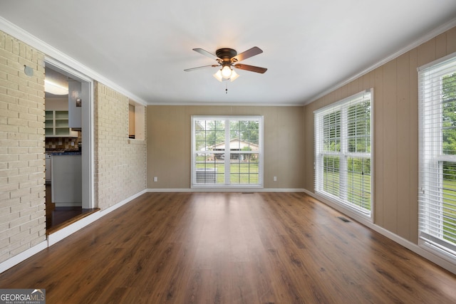 701 W Nance Springs Rd SW, Dalton, GA 30721 - empty room featuring healthy amount of natural light, ceiling fan, wood finished floors, crown molding, and baseboards