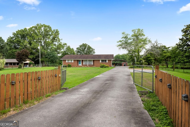 701 W Nance Springs Rd SW, Dalton, GA 30721 - ranch-style home featuring a gate, driveway, a detached carport, and view of scattered trees