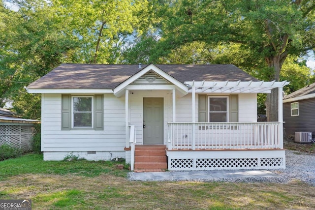 bungalow with cooling unit, covered porch, crawl space, and a shingled roof