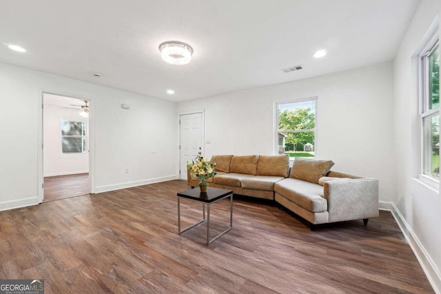 living room featuring dark wood-style floors, baseboards, and recessed lighting