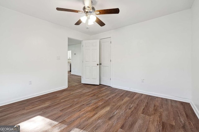 unfurnished room with baseboards, a ceiling fan, and wood finished floors