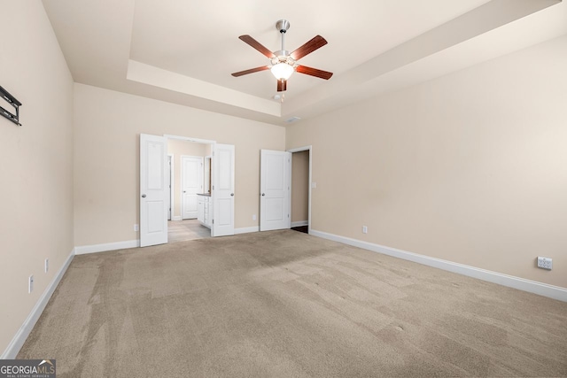 2431 Kingston Heath Way, Marietta, GA 30008 - unfurnished bedroom featuring a tray ceiling, light carpet, baseboards, and ensuite bathroom