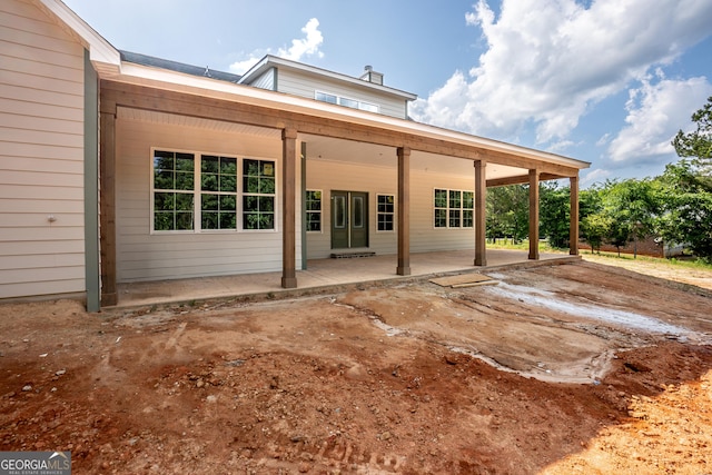 back of property with a porch