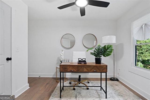 office space with wood finished floors, baseboards, and a ceiling fan