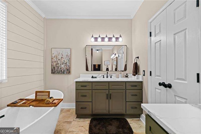 bathroom with crown molding, vanity, a soaking tub, and baseboards