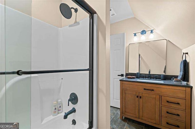 full bathroom featuring vaulted ceiling and vanity