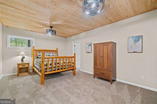 carpeted bedroom featuring wood ceiling and baseboards