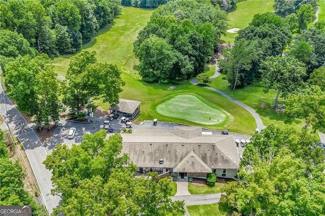 aerial view of a golf course and a tree filled landscape