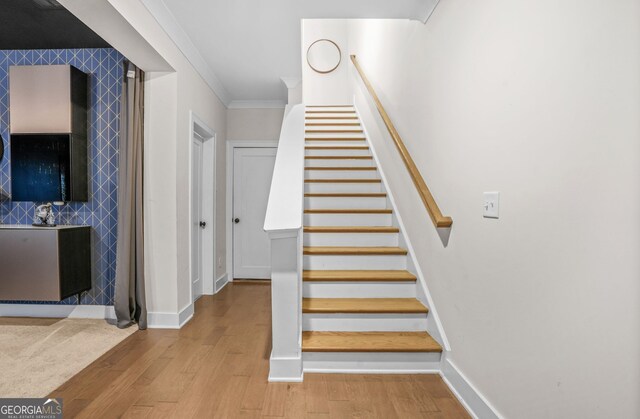 2744 Bell Dr SE, Smyrna, GA 30080 - stairway featuring wood finished floors, baseboards, and crown molding