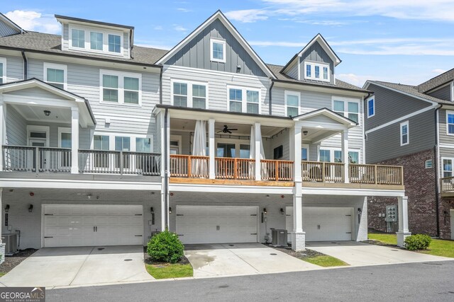 2744 Bell Dr SE, Smyrna, GA 30080 - view of front of property featuring a garage, central air condition unit, board and batten siding, and concrete driveway