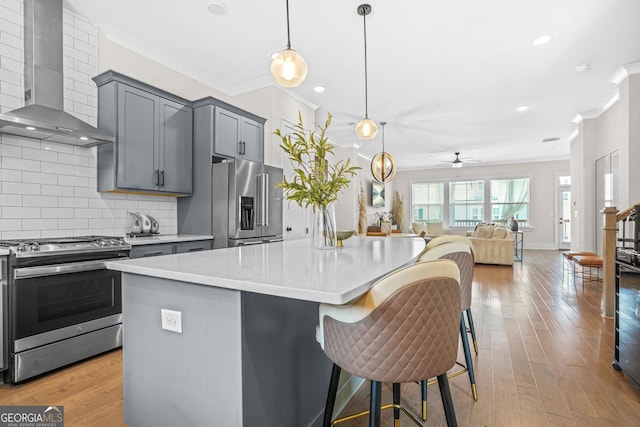 2744 Bell Dr SE, Smyrna, GA 30080 - kitchen with appliances with stainless steel finishes, wall chimney range hood, crown molding, ceiling fan, and gray cabinetry