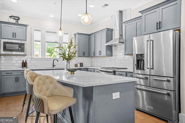 2744 Bell Dr SE, Smyrna, GA 30080 - kitchen featuring appliances with stainless steel finishes, wall chimney range hood, gray cabinets, a sink, and ornamental molding
