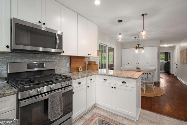 283 Norton Cir SE, Smyrna, GA 30082 - kitchen featuring stainless steel appliances, plenty of natural light, decorative backsplash, and white cabinets