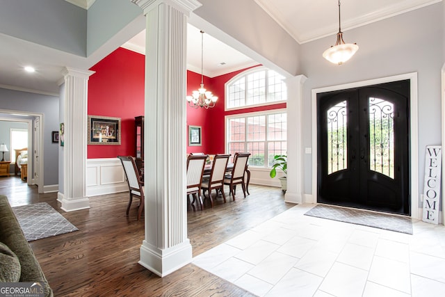 1365 Ivy Plantation, Monroe, GA 30656 - foyer featuring ornate columns, ornamental molding, french doors, a towering ceiling, and wood finished floors