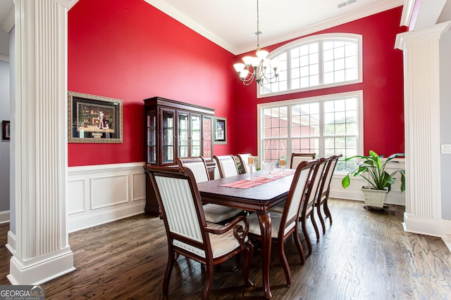1365 Ivy Plantation, Monroe, GA 30656 - dining room featuring ornate columns, crown molding, dark wood-style flooring, a chandelier, and a towering ceiling