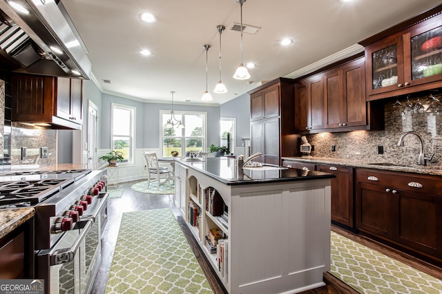 1365 Ivy Plantation, Monroe, GA 30656 - kitchen with ventilation hood, range with two ovens, dark wood-style floors, crown molding, and a center island with sink