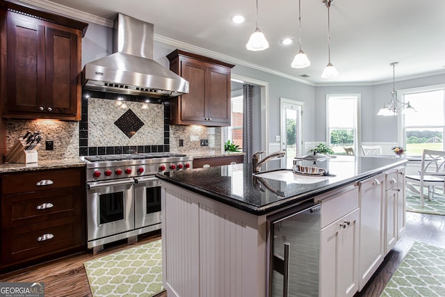 1365 Ivy Plantation, Monroe, GA 30656 - kitchen featuring wall chimney range hood, range with two ovens, wine cooler, dark wood-style floors, and crown molding