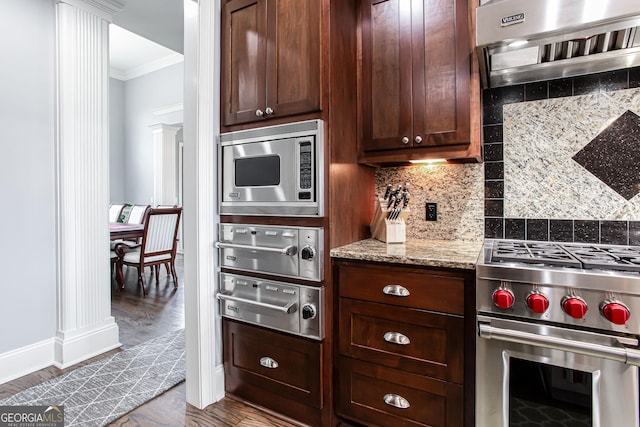 1365 Ivy Plantation, Monroe, GA 30656 - kitchen featuring stainless steel appliances, crown molding, extractor fan, a warming drawer, and light stone countertops