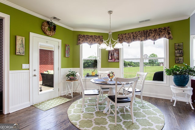 1365 Ivy Plantation, Monroe, GA 30656 - dining room featuring dark wood-type flooring, ornamental molding, wainscoting, and a chandelier