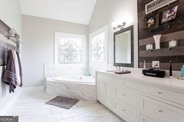1365 Ivy Plantation, Monroe, GA 30656 - bathroom featuring vanity, marble look tiles, a garden tub, vaulted ceiling, and baseboards
