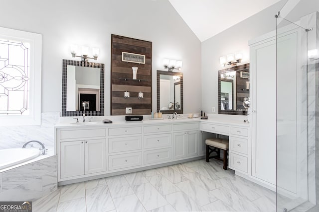 1365 Ivy Plantation, Monroe, GA 30656 - full bathroom featuring vaulted ceiling, double vanity, a bath, a shower, and marble look tiles