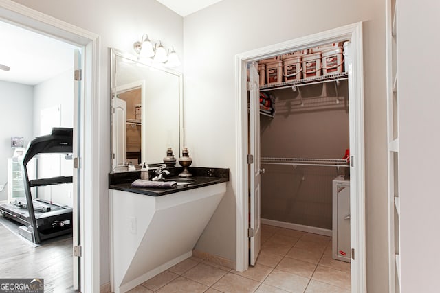1365 Ivy Plantation, Monroe, GA 30656 - bathroom with a sink, a walk in closet, and tile patterned flooring