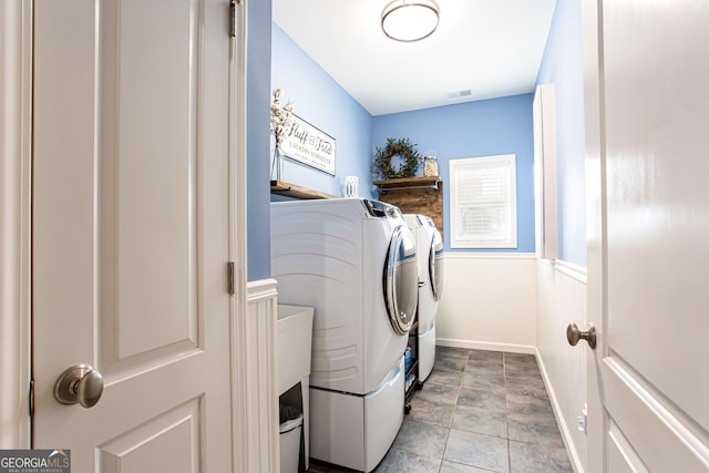 1365 Ivy Plantation, Monroe, GA 30656 - washroom featuring washing machine and dryer, baseboards, and stone finish floors