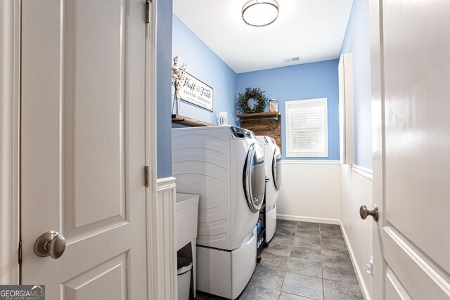 1365 Ivy Plantation, Monroe, GA 30656 - washroom featuring washing machine and clothes dryer and stone finish floors